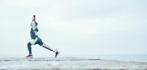 woman stretching her prosthetic legs on a run