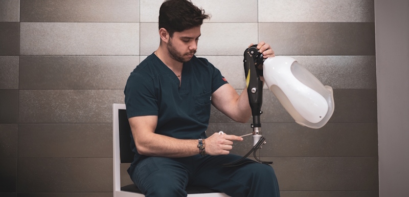 an orthopedist fixing a prosthetic leg for an athlete.bionic leg