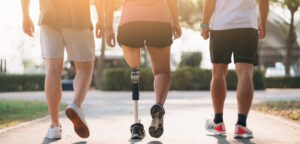 individual with prosthetic leg on a group walk outdoors