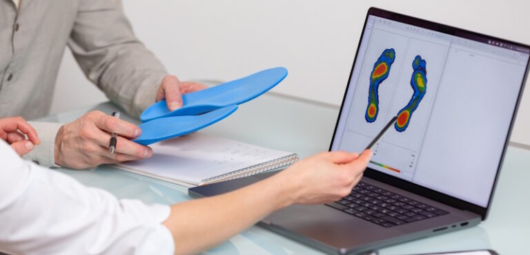 orthotic specialists looking at scan