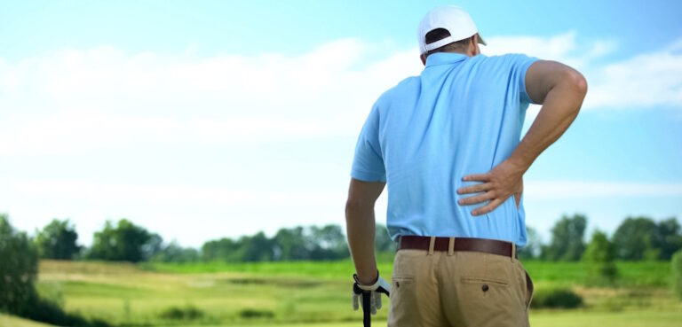 golfer rubbing his sore back
