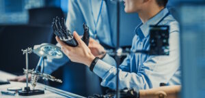 prosthetist holding prosthetic hand