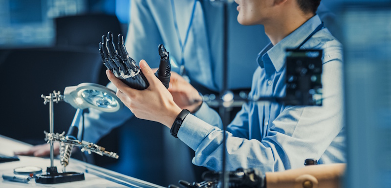 prosthetist holding prosthetic hand